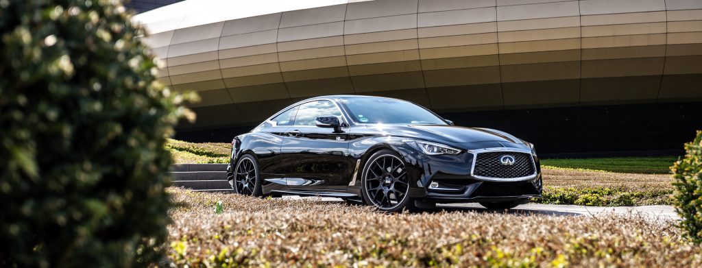 Infiniti Q60 parked in front of building featuring HP Tuners software.
